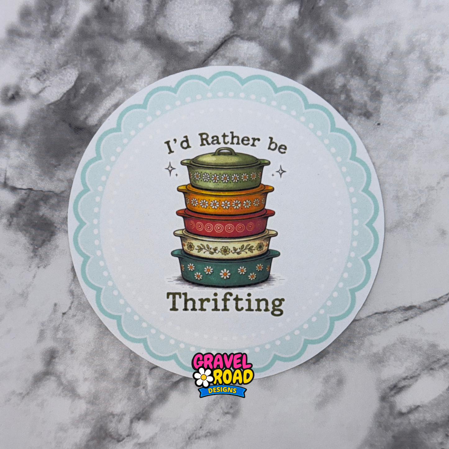 Round sticker with colorful pots and text 'I'd Rather be Thrifting' on a marble background
