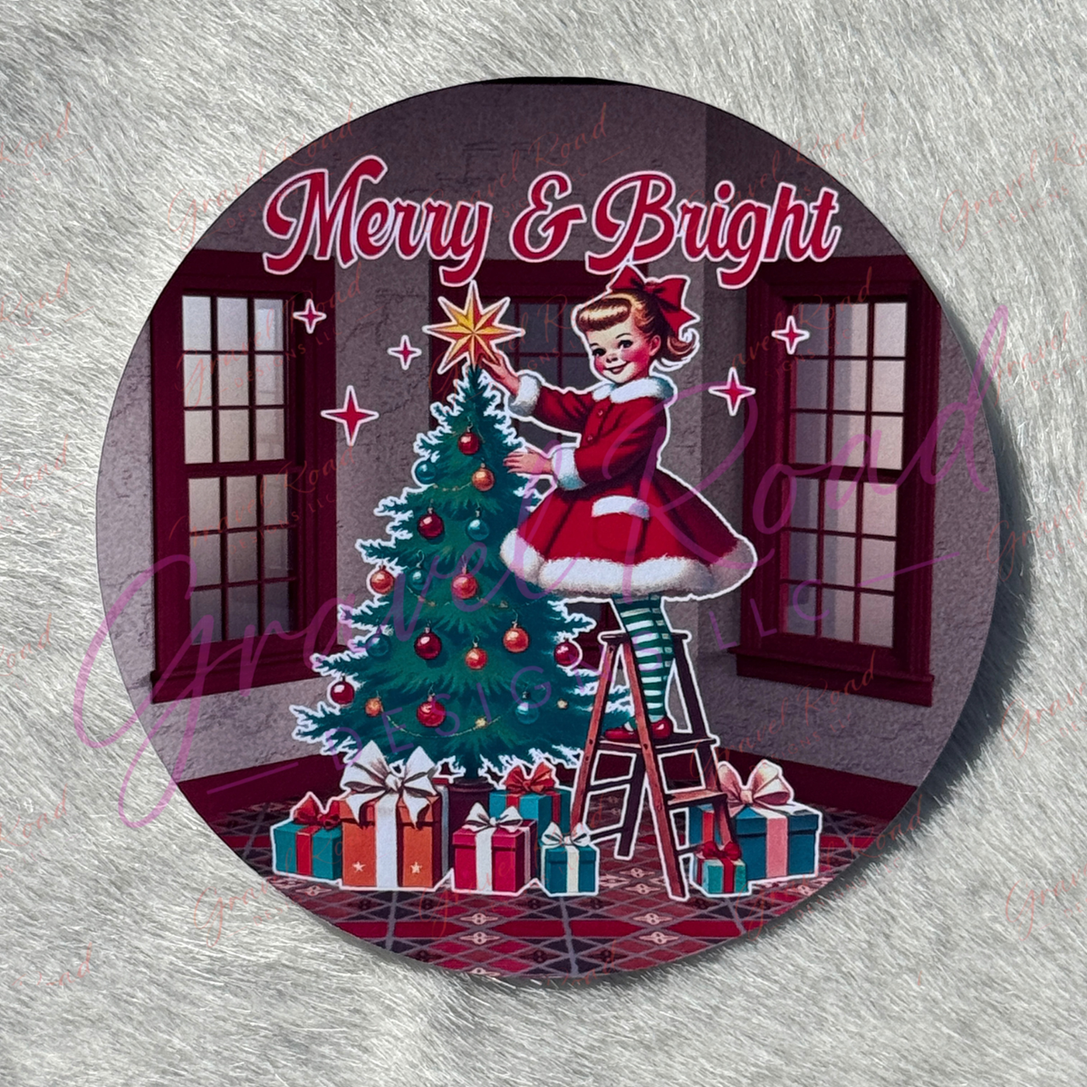 A round printed cardstock featuring a vintage Christmas illustration with a girl in a red dress decorating a tree, wrapped presents, and the words “Merry & Bright,” displayed on faux fur background.