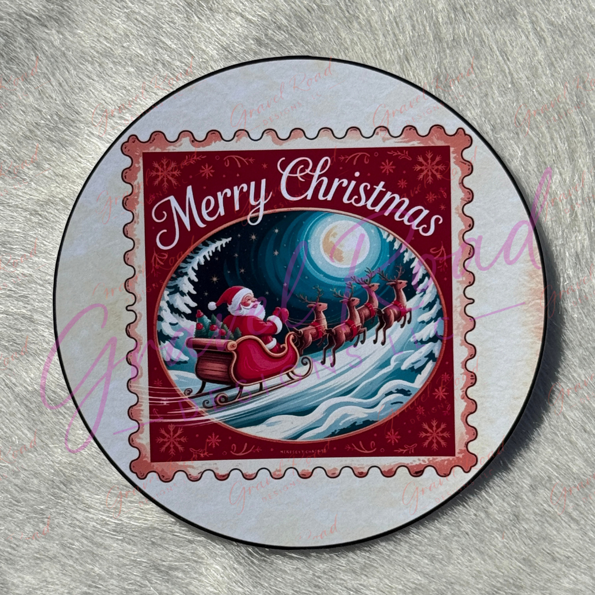 A festive postage‑stamp style cardstock of Santa riding in a red sleigh pulled by four reindeer across a snowy landscape under a bright full moon, with a dark blue starry sky, snow‑covered trees, and the phrase “Merry Christmas” written in white script across the top. Displayed on a faux fur background