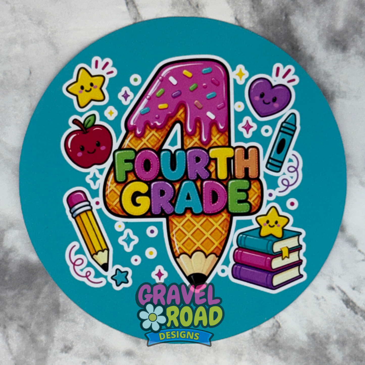 A round cardstock with a colorful 'Fourth Grade' design, featuring a waffle cone shaped number 4, a pink-frosted donut, a pencil, books, stars, and the logo 'Gravel Road Designs' on a gray marble background.