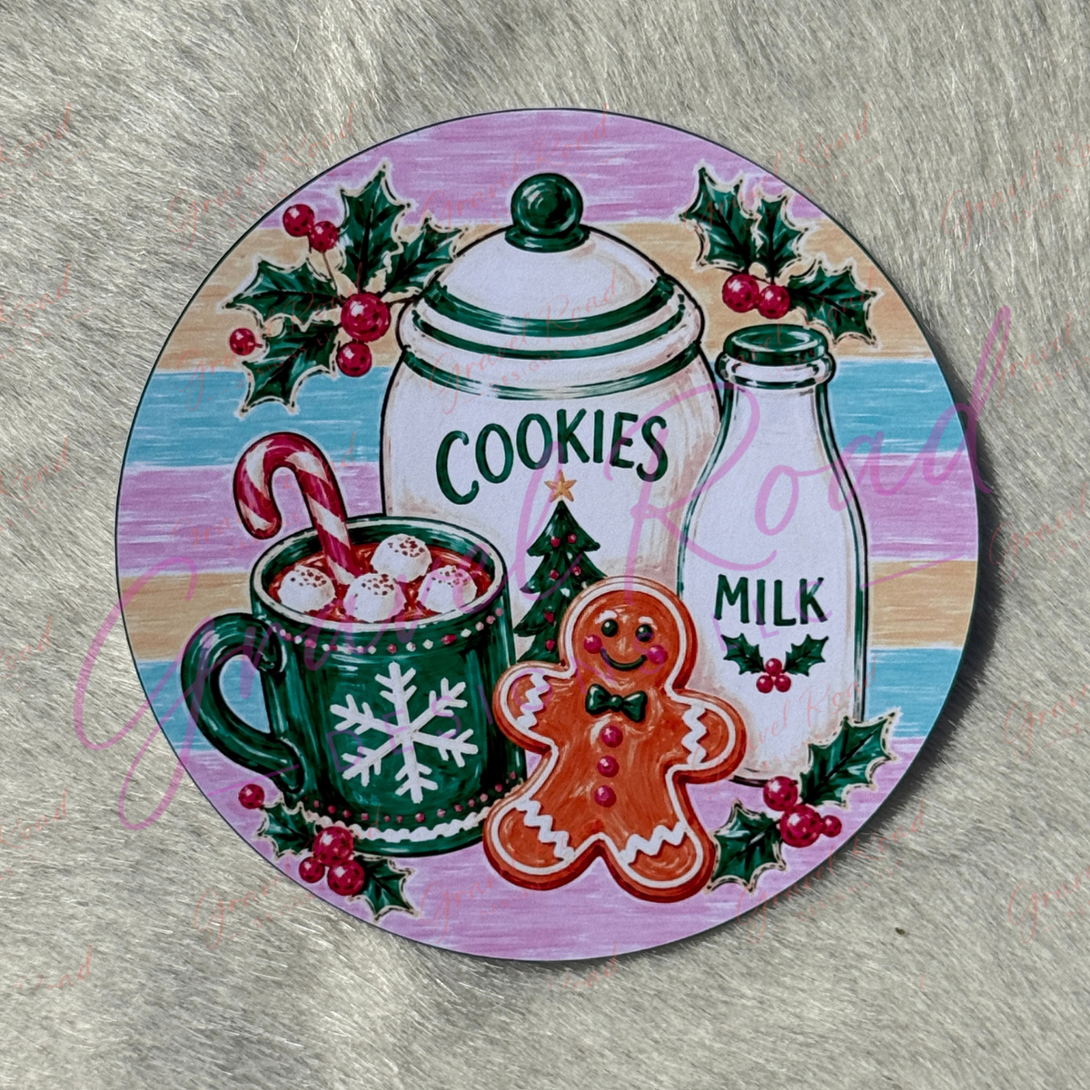 A round cardstock featuring a festive Christmas illustration with a gingerbread man, cookies jar, milk bottle, mug of hot cocoa with marshmallows, candy cane, holly, and berries on a pastel striped background. Displayed on grey faux fur background.