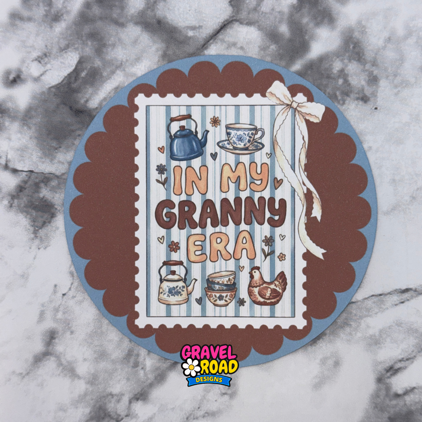 Decorative circular printed cardstock with 'In My Granny Era' text and Gravel Road Designs logo on a marble background