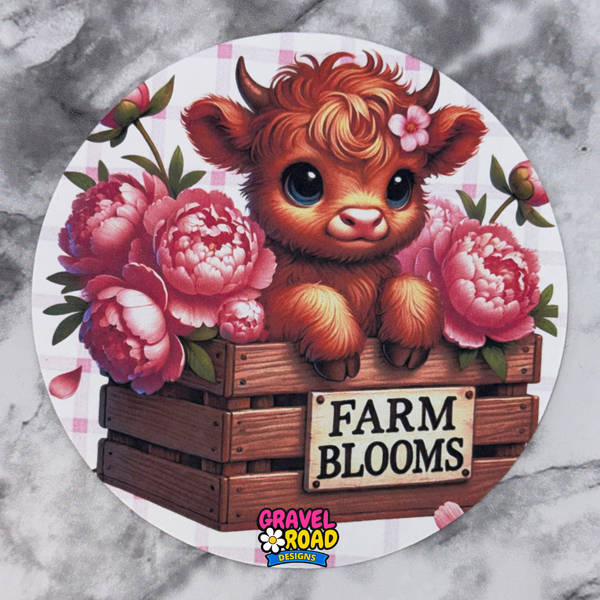 Circular design with a cartoon cow and flowers, featuring the brand 'Gravel Road Designs'.
