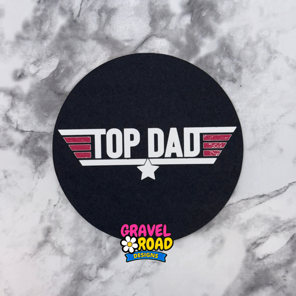 Black round cardstock with 'Top Dad' design on a marble surface, featuring Gravel Road Designs logo.