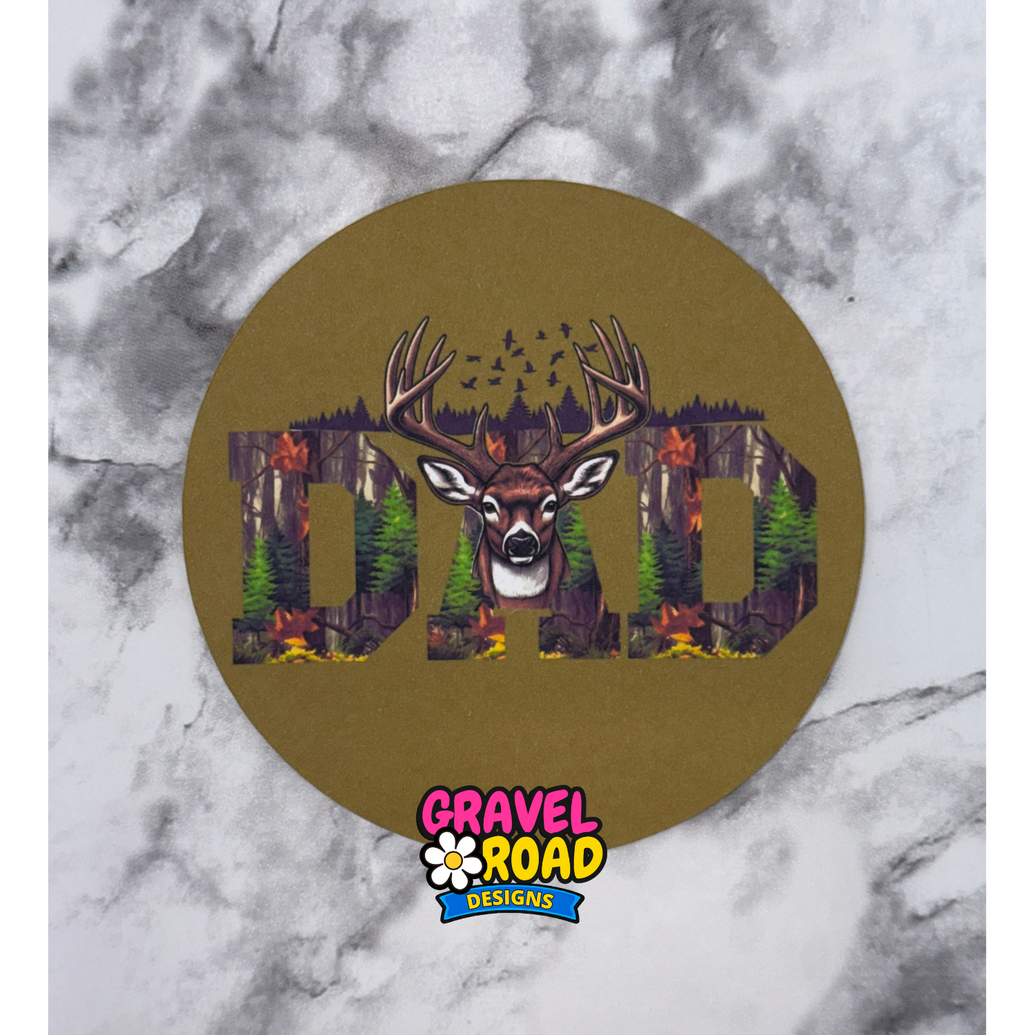 Circular design with a deer and 'DAD' text on a marble background, featuring the Gravel Road Designs logo.