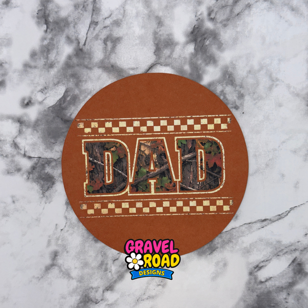 Round brown cardstock with 'DAD' in camouflage pattern on a marble background, featuring Gravel Road Designs logo.