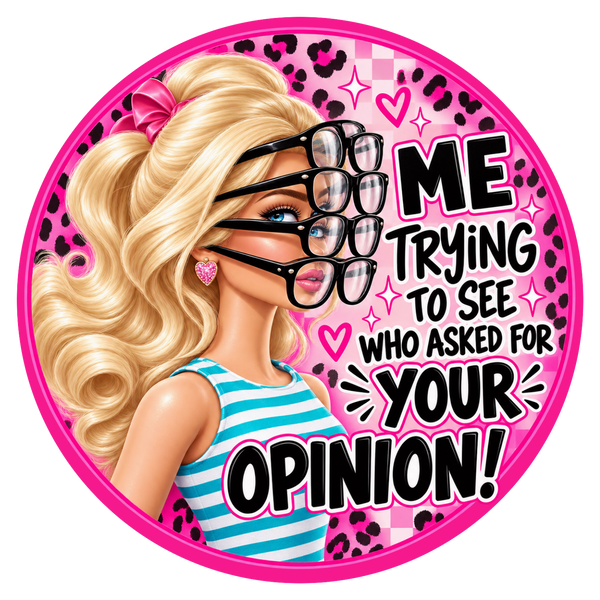 A circular sticker or graphic featuring a blonde doll-like character with wavy hair, black eyeglasses layered over another pair, a pink bow, and a blue-and-white striped top. The background is pink with leopard print, hearts, and the text 'ME TRYING TO SEE WHO ASKED FOR YOUR OPINION!'.