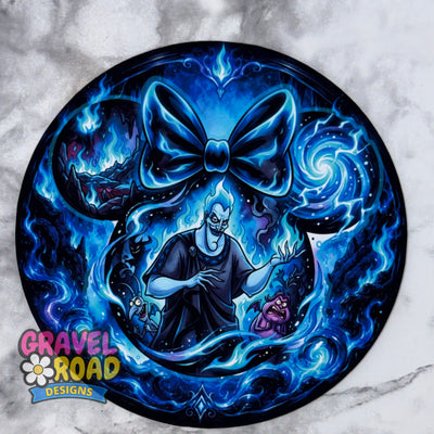A circular custom graphic print featuring a cartoon style man, styled in a tattoo flash design with a large glowing blue bow on a marble background. The artwork is signed by Gravel Road Designs in the bottom-left corner. On a grey marble backdrop.