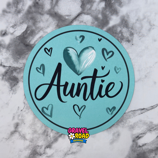 Round teal printed cardstock with 'Auntie' text and hearts on a marble background, featuring Gravel Road Design logo.