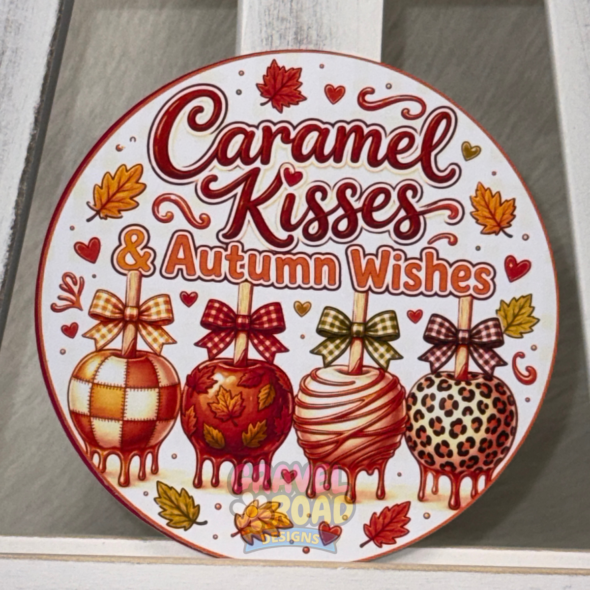 Round fall cardstock with four decorated caramel apples, autumn leaves, bows, and the phrase “Caramel Kisses & Autumn Wishes.”
