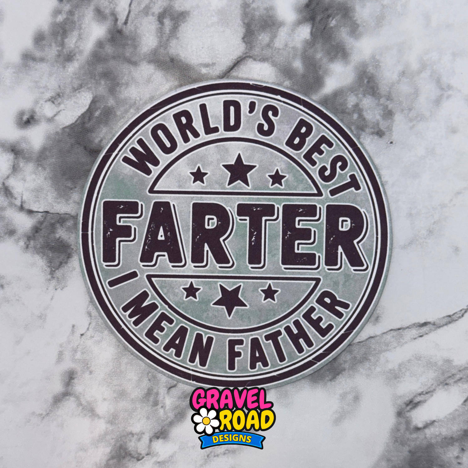 Round cardstock with 'World's Best Farter, I Mean Father' text on a marble background with Gravel Road Designs logo.