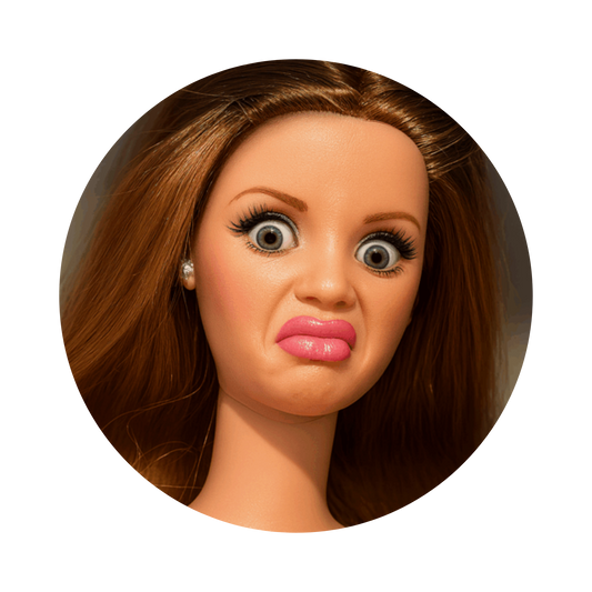 A close-up circular portrait of a doll or toy head with brown hair, large expressive eyes, and pink lips, shown on a plain white background.
