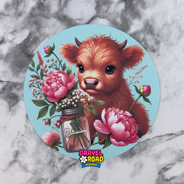 Circular design with a cow and flowers on a marble background