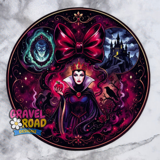 A circular cardstock featuring a dark fantasy illustration of a Queen-like character in a purple gown with a large magenta bow above her head, surrounded by gothic motifs including a castle, a blue mirror portrait, a crow, and an apple. The design is shown on a light marble-like background, with the logo 'GRAVEL ROAD DESIGNS' in the lower-left corner.