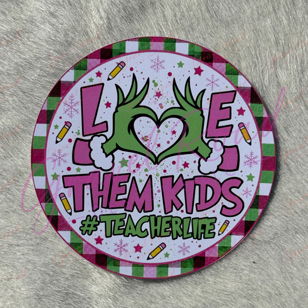 A round printed cardstock with a festive holiday design, featuring the text 'LOVE THEM KIDS #TEACHERLIFE' with a green heart made from hands, set against a gray faux fur background.