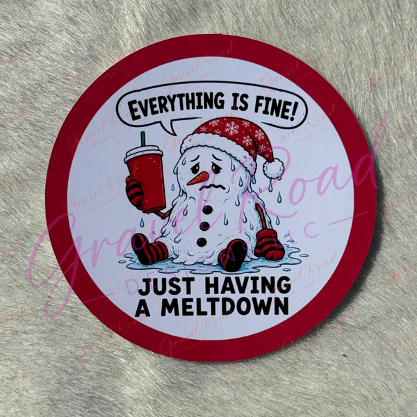 A circular cardstock with a red border and a cartoon snowman holding a red drink, with the text 'EVERYTHING IS FINE! JUST HAVING A MELTDOWN' on a gray faux-fur background.