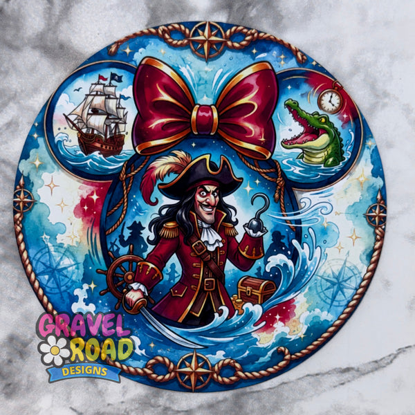 A circular pirate-themed cardstock featuring a central cartoon pirate with a large red bow, blue ocean waves, a ship, an alligator, and compass motifs, shown on a light marble-patterned background. The Gravel Road Designs logo appears in the lower left. On a grey marble backdrop.