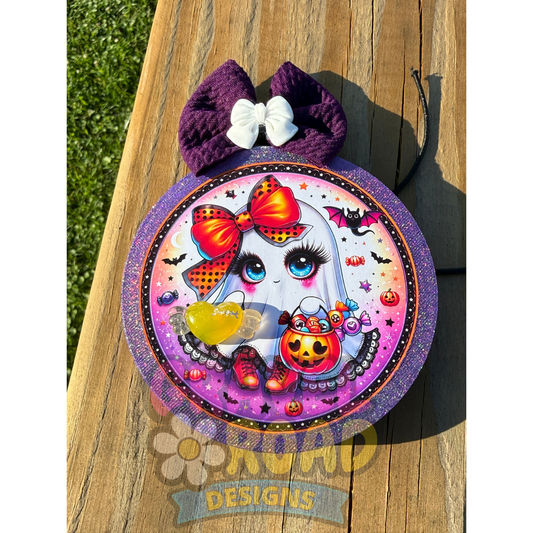 Purple glitter Halloween car freshie featuring a cute ghost with candy, orange bow, purple fabric bow, and yellow candy bead.